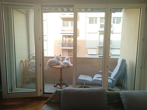 sala de estar con sofá y ventana grande en Espacioso apartamento en Ginebra