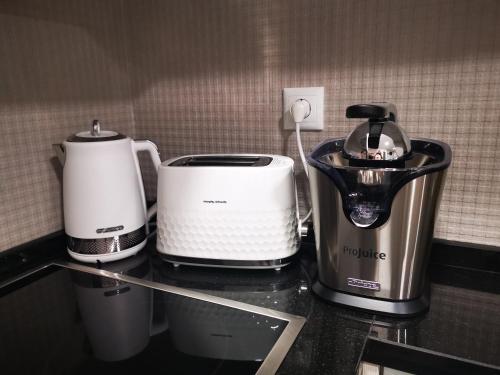 a counter with two toasters and a blender on it at Apartamento ms in Campo Maior