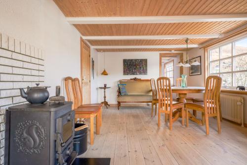 a living room with a table and a stove at Lovely 4 Bedroom House in Vestmanna in Vestmanna