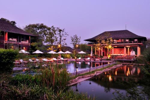 a resort with a pool in front of a building at Kirimaya Golf Resort Spa - SHA Plus Certified in Mu Si
