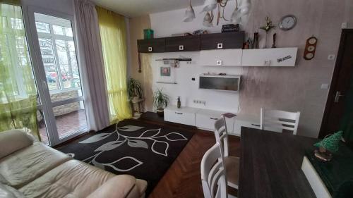 a living room with a couch and a table at Apartament Kimi&Maxi in Varna City