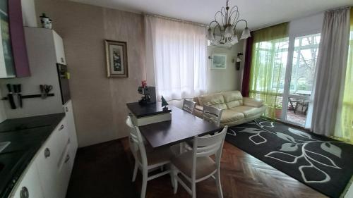 a kitchen and living room with a table and a couch at Apartament Kimi&Maxi in Varna City