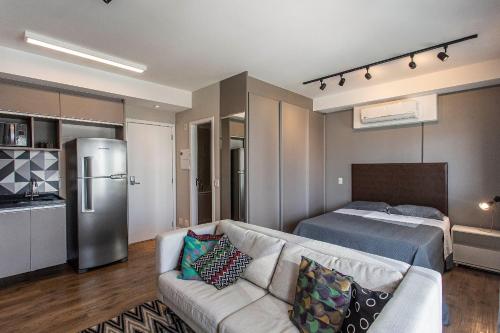 a living room with a couch and a bed at ADD Berrini in Sao Paulo