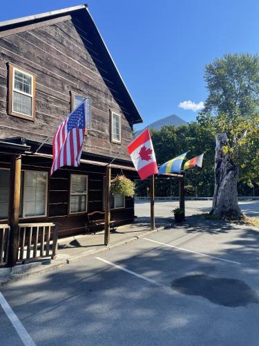 a group of flags in front of a building at North Cascades Inn in Marblemount