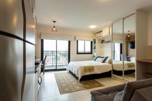 a bedroom with a bed and a large window at Is Moema in Sao Paulo