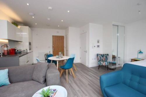a living room with a couch and a table at 5* Cambridge Boutique Apartment in Trumpington