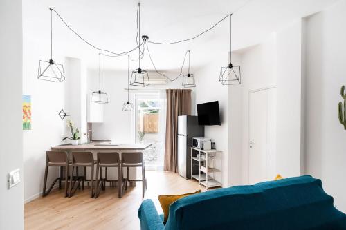 a living room with a blue couch and a table at Yellow Apartment in Bari