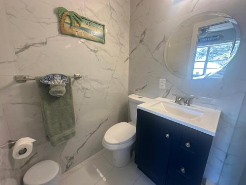 a bathroom with a toilet and a sink and a mirror at Dream Studio on the Beach in Miami Beach