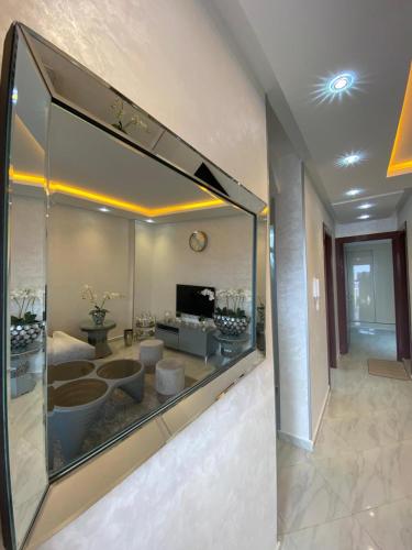 a large mirror in a room with a living room at Mini villa 1 Al hoceima in Al Hoceïma