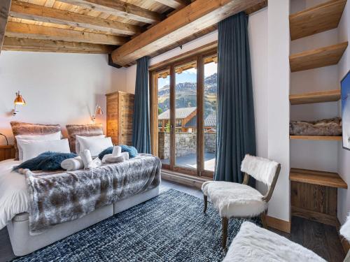 a bedroom with a bed and a large window at Appartement Val-d'Isère, 5 pièces, 8 personnes - FR-1-567-68 in Val-d'Isère