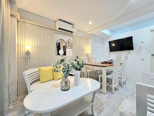 a living room with a couch and a table at 39 Living Pattaya in Pattaya