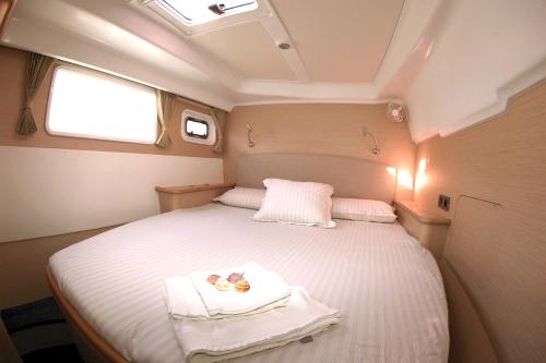 a small bedroom with a bed in the middle at Catamaran Lagoon 450 in Ibiza Town