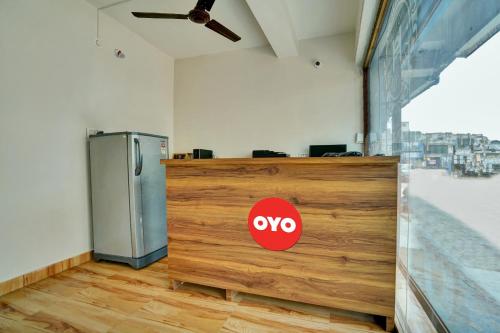 a kitchen with aevoice sign on a wooden counter at OYO Flagship Hotel The Cloud in Bhilai
