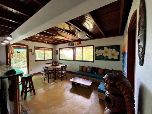 a living room with a couch and a table at Casa’ Mapola : typical beach jungle house in Pavones