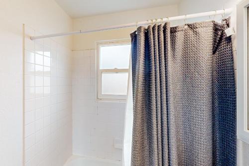 a bathroom with a shower with a shower curtain at Midtown Hideaway in Coeur d'Alene