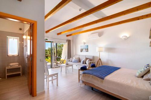 a bedroom with a bed and a living room at Quinta Tapada dos Machados in Alvor