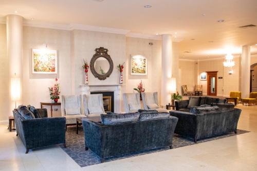 a living room with couches and a fireplace at Grand Hotel in Malahide
