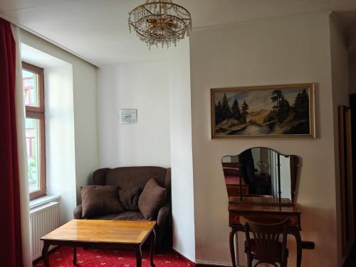 Mariahilf Citycenter Hotel في فيينا: غرفة معيشة مع أريكة وطاولة