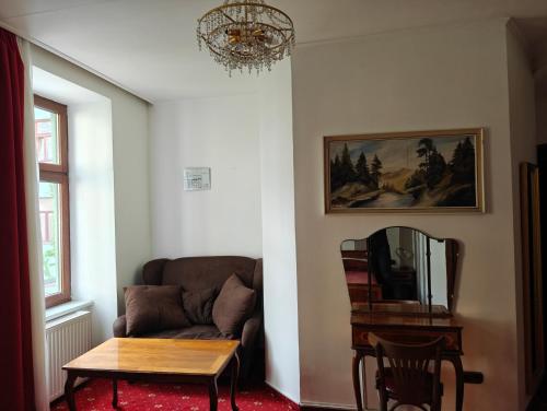 a living room with a couch and a table at Mariahilf Citycenter Hotel in Vienna