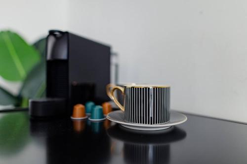 a coffee cup sitting on top of a table at Kerkstraat Residence in Amsterdam