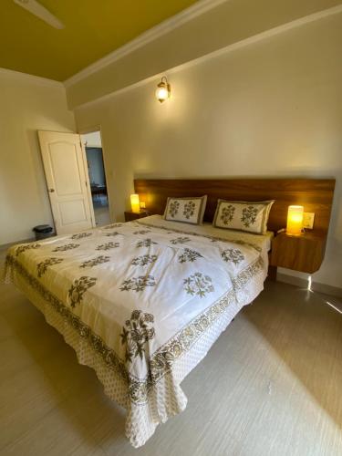 a bedroom with a large bed with two pillows at SEPIA STOREYS in Porvorim