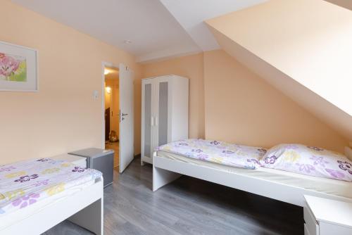 sypialnia z 2 łóżkami i schodami w obiekcie Messe Monteurzimmer Köln w Kolonii