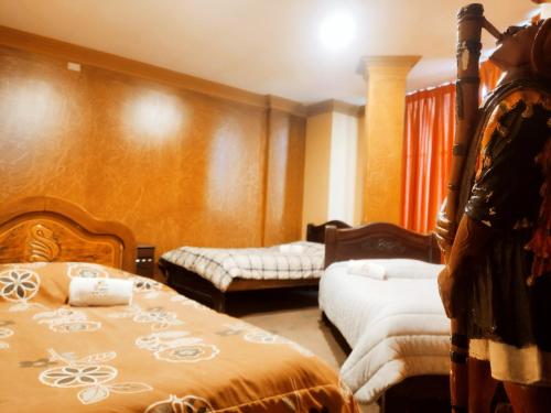 a bedroom with two beds in a room at HOTEL MIRADOR DE LOS ANDES in La Paz