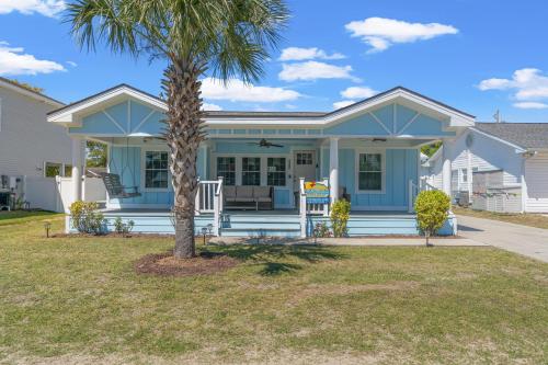 a house with a palm tree in front of it at Low Tide - 3rd Row - Crescent Beach Section in Myrtle Beach