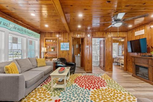 a living room with a couch and a tv at Low Tide - 3rd Row - Crescent Beach Section in Myrtle Beach