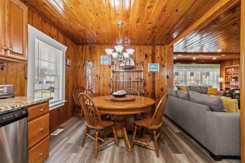 a kitchen and dining room with a table and a couch at Low Tide - 3rd Row - Crescent Beach Section in Myrtle Beach