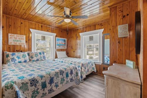 a bedroom with a bed and a ceiling fan at Low Tide - 3rd Row - Crescent Beach Section in Myrtle Beach