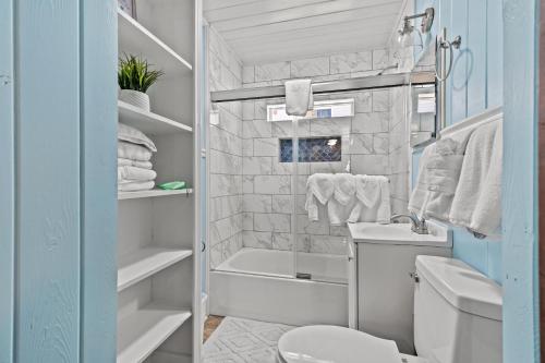 a small bathroom with a toilet and a sink at Low Tide - 3rd Row - Crescent Beach Section in Myrtle Beach