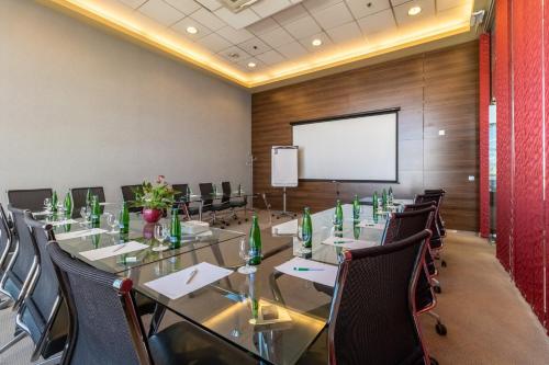 a conference room with a long table and chairs at Holiday Inn Zilina by IHG in Žilina