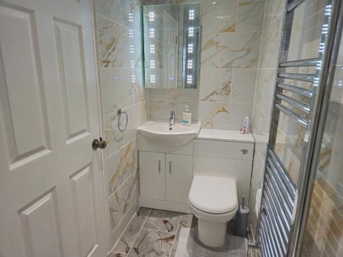 a white bathroom with a toilet and a sink at Modern En-suite Doubles in Boston Town Spacious & Contemporary Rooms in Boston