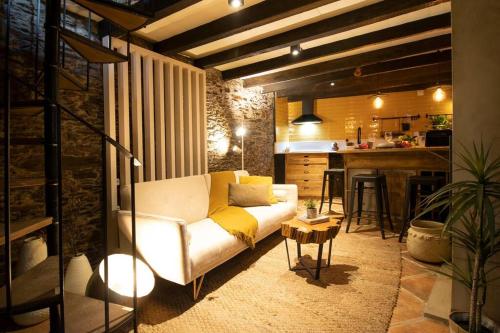 a living room with a couch and a kitchen at Casa da Serra - Mountain Home in Arganil