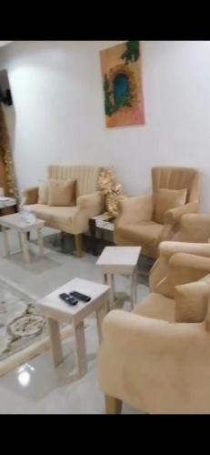 una sala de estar con sofás y mesas. en استراحة زمردة en Khasab