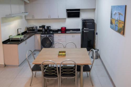 a kitchen with a wooden table and chairs in it at Kawsay Apart in La Paz