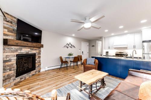 a living room with a fireplace and a kitchen at Estes Park Vacation Rental 1 Mi to National Park in Estes Park