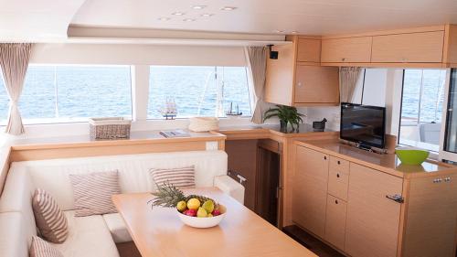 a kitchen and living room in a boat with a table at Catamaran Lagoon 450 in Ibiza Town
