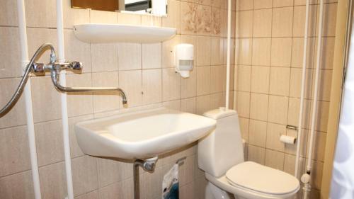 a small bathroom with a sink and a toilet at A Hotels Roskilde in Hedehusene