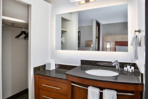 a bathroom with a sink and a mirror at Candlewood Suites - Cincinnati Northeast - Mason, an IHG Hotel in Mason