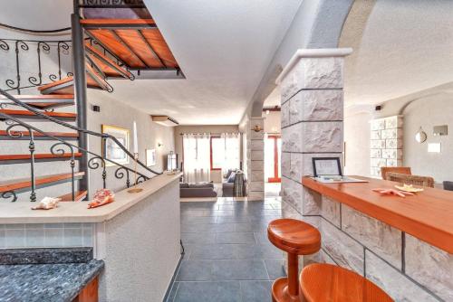 a lobby with a bar and a staircase at Villa Silversea in Hvar infinity heated pool in Hvar