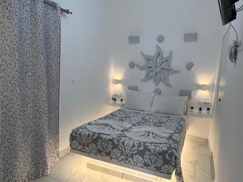 a bedroom with a bed and a shower curtain at Villa Pavlina in Karterados