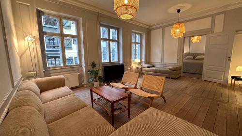 a living room with a couch and a table at The Admirals Apartments - Carolinas apartments in Copenhagen