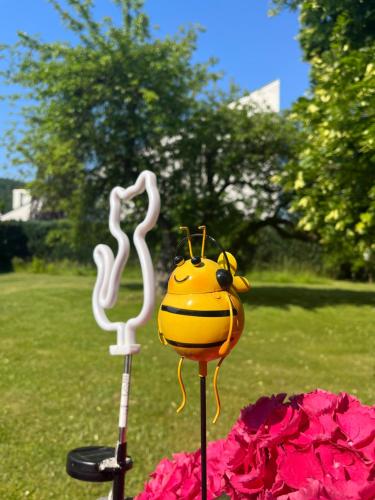 a statue of a lady bug on a pole in the grass at FEWO-ATLANTA Reinhardshausen in Reinhardshausen