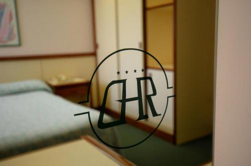 a room with a bed with the letter h on it at Grand Hotel delle Rocche in Rocca di Mezzo