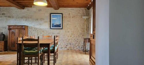 une salle à manger avec une table et des chaises dans l'établissement La clef des chants, à Longueville