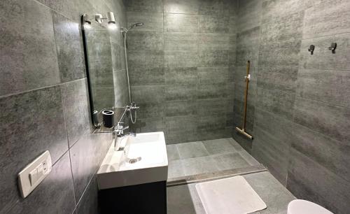 a bathroom with a sink and a shower and a toilet at Imperial Resort Apartment XL 1 Bed in Hurghada