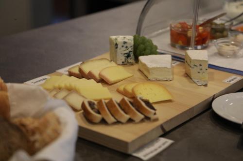 a cutting board with cheese and other foods on it at Hotel B&B Stossplatz in Appenzell