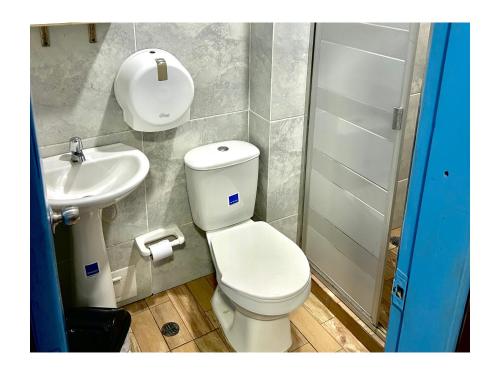 a bathroom with a toilet and a sink at Kasaya Hotel in Santa Marta